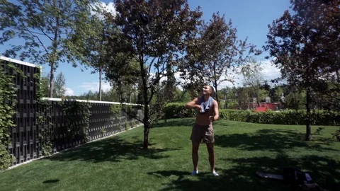 Man throws a cap up and tries to catch her with his head Stock Footage 102250279