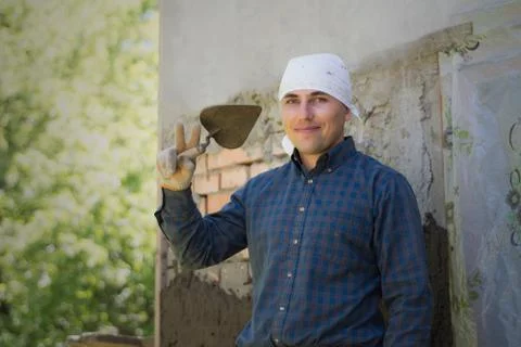 A man throws a cement mortar on a brick wall Stock-Fotos