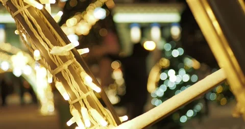 A man throws a child up to bring him joy next to a Christmas tree. Vídeos de archivo 296103060