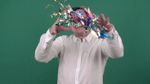 A man throws up colored confetti and jumps on a green background. Slow motion Stock Footage 150582343