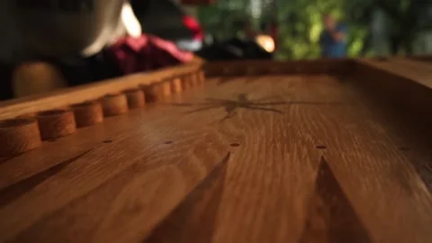 A man throws dice on a wooden board before playing backgammon Stock Footage 161042910