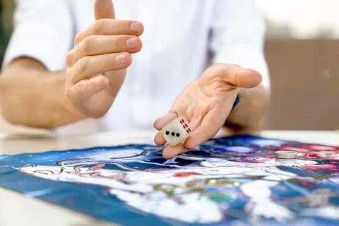 Man Throws Die on Playing Field of Leela's Game, Hands Close up, Turkey, Al.. Stock Photos