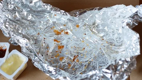 Man throws a dirty napkin in empty food package. Stock Footage 70403770