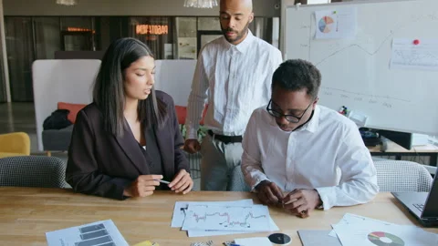 Man throws documents with graphs on table as sign of dissatisfaction with work Vidéo 335732318