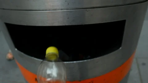 Man throws empty recycling plastic bottle into litter bin. Stock Footage 129974422