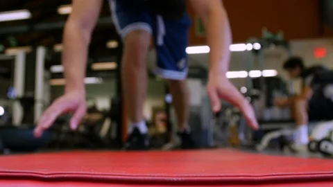 Man Throws Exercise Mat On Ground to Work Out push up Stock Footage 125303363