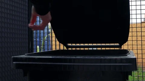 A man throws a full trash bag into a bin - closeup Video stock 81203606