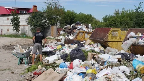 A man throws garbage at the city dump Stock Footage 93709125