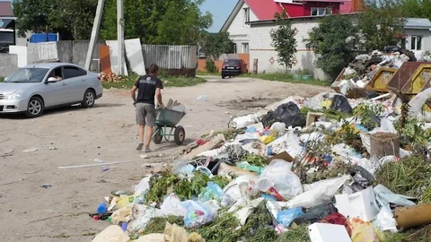 A man throws garbage at the city dump Stock Footage 93709205