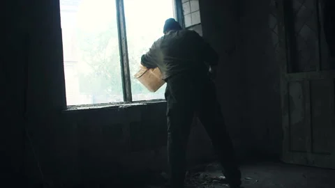 Man throws garbage in the window of the house Stock Footage 108550073