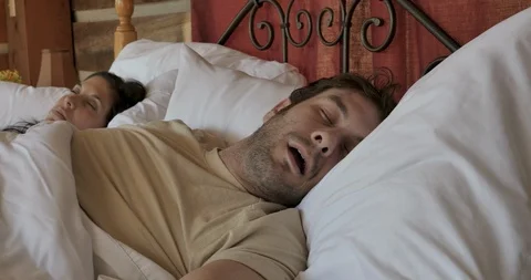 Man throws his smart phone after he is woken up by a notification or alarm Stock Footage 107393455