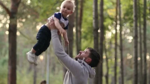 A man throws his son up and he laughs happily Stock Footage 141921259