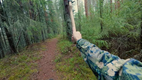 A man throws an old rusty axe into a tree and misses.From the first person. Stock Footage 320944539