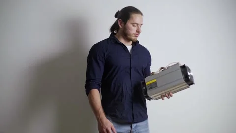 A man throws out an ASIC for mining bitcoins, a crypto scam, a miner is Stock Footage 155055247