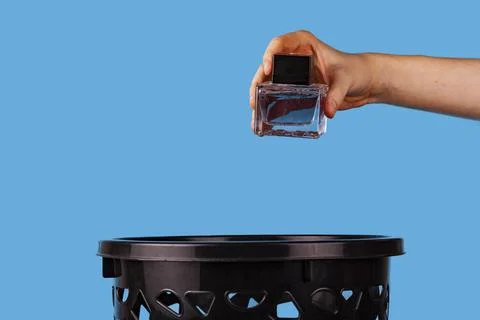 Man throws out perfume. Stock Photos
