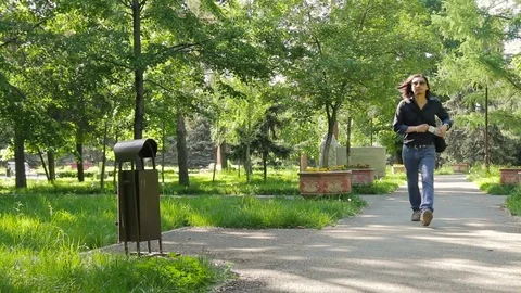 Man throws out plastic bottle in the urn misses and walks away Environmental Stock Footage 75983023