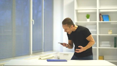 The man throws the phone on the table. slow motion Stock Footage 99227491