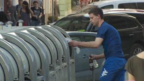 Man throws plastic bags, garbage into a trash can containers. glass bottles Stock Footage 132252245