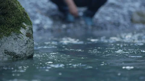 A man throws a stone into the water Stock Footage 263424449
