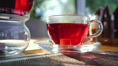 Man throws sugar into the tea and stirs it Stock Footage 141864644