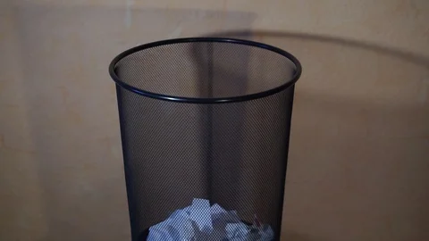 Man throws trash in a bucket Stock Footage 98366502