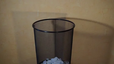 Man throws trash in a bucket Stock Footage 98366586