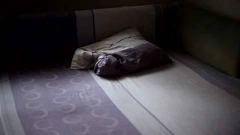 The man throws two pillows on the bed. Preparing a bed for sleep or rest. Stock Footage 154007736
