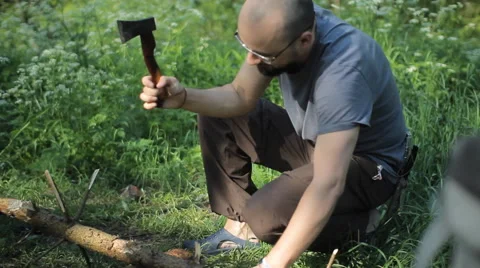 Man throws wood on the fire in the camping. Early morning in the forest Stock Footage 64325276