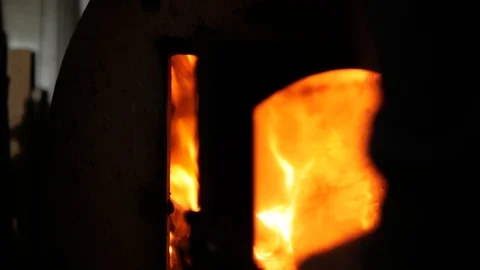 A man throws wood in the stove Stock Footage 99576944