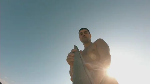 A man throws a wooden spear with a camera on the beach. Stock Footage 157921386