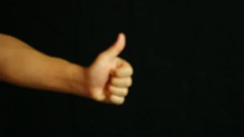 Man thumbs up with black background , closing in studio Chiangmai Thailand Stock Footage 102092516
