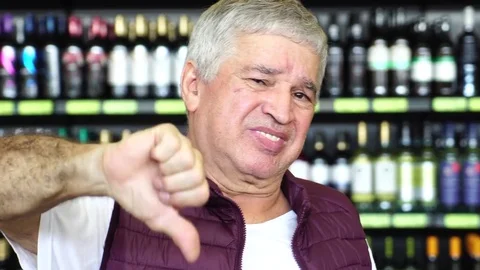 Man Thumbs Down - Dissatisfied with Bottles on background Stock Footage 85067655