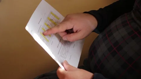 Man thumbs through the schedule Stock Footage 68991447