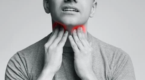 Man with thyroid gland problem, touching his neck Stock Photos