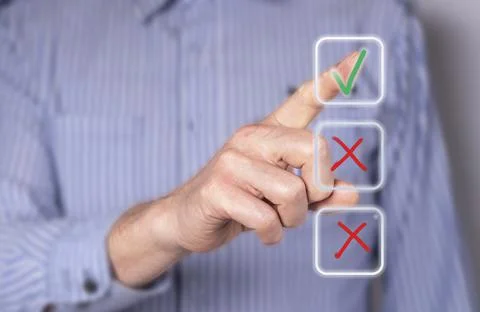 Man ticking right answer at digital screen with check mark. Businessman takin Stock Photos