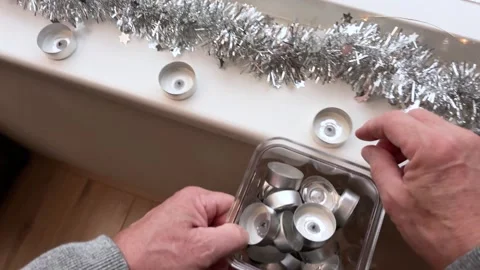 A man tidily gathers empty candlelight caps Stock Footage 321481541