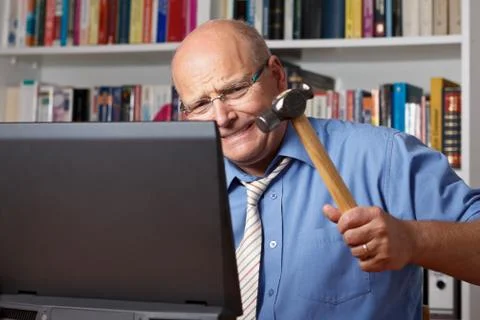 Man tie hitting computer hammer Stock Photos