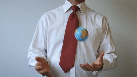 Man in a tie with a red colour, is throwing the globe Stock Footage 114929065