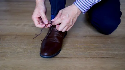 A man tie a shoelace Stock Footage 129176193