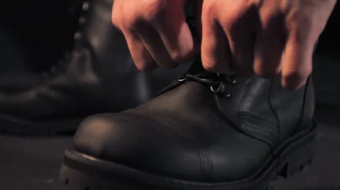 Man ties boots Stock Footage 62470543