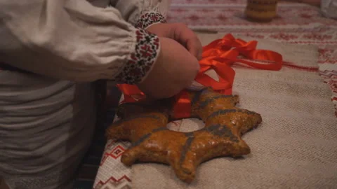 A man ties a pie with a red ribbon to perform an ancient rite Stock Footage 145376246