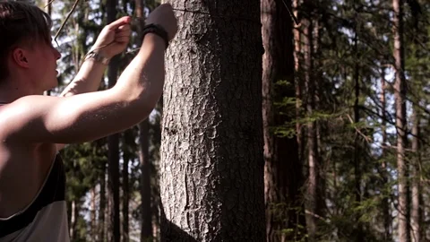 Man ties a quick release knot around a tree Stock Footage 91708302