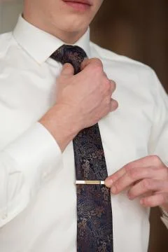 The man ties a tie Stock Photos