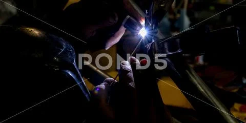 Man tig welding with brilliant bright white star burst bloom Stock Photos