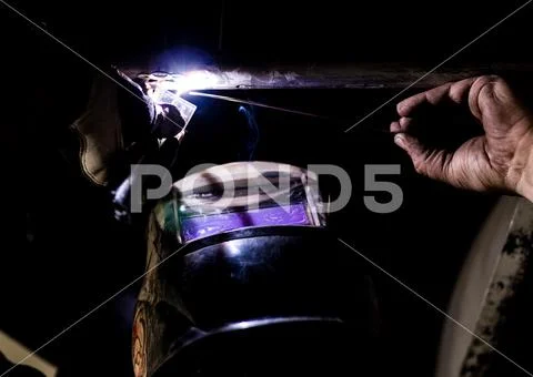 Man tig welding with brilliant bright white star burst bloom Stock Photos