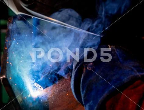 Man tig welding steel plates with brilliant bright white star burst bloom Stock Photos