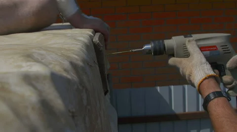 A man tightening the bolt with a drill Stock Footage 64775899