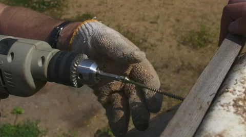 A man tightening the bolt with a drill Stock Footage 64776015