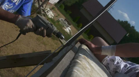 A man tightening the bolt with a drill Stock Footage 64776049