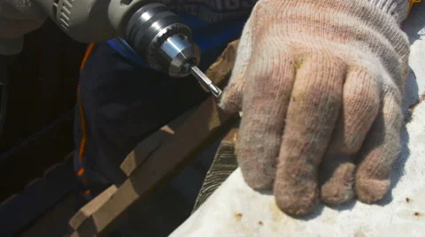 A man tightening the bolt with a drill Stock Footage 64776151
